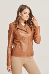Woman wearing a brown leather jacket on a plain background