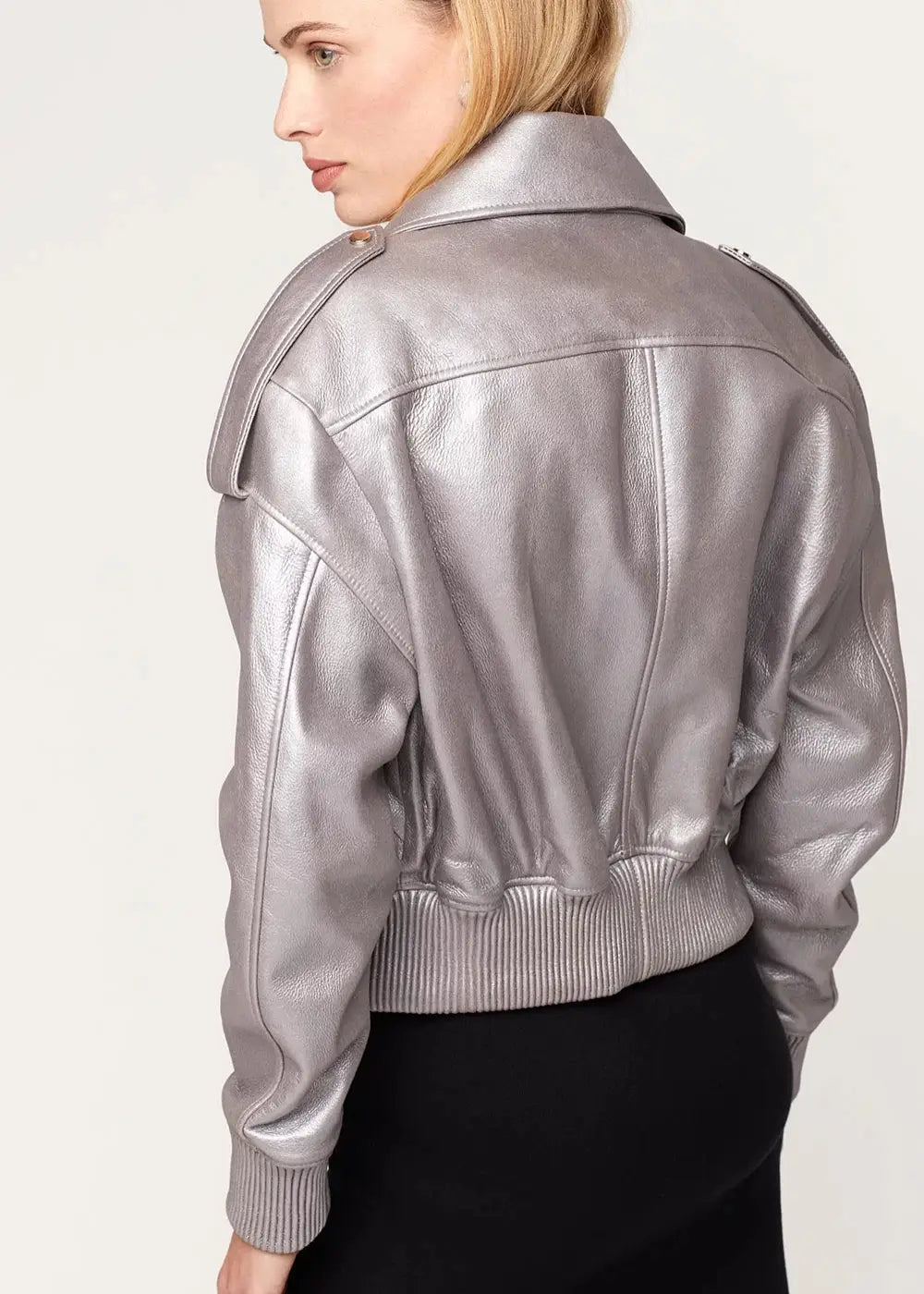 Silver leather jacket worn by a person on a white background